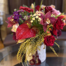 Bouquet of red and pink flowers in a white vase