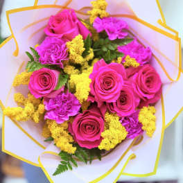 Bouquet of hot pink roses and carnations with yellow filler flowers