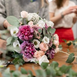 Hand-tied bouquet of pink, white, and purple flowers with eucalyptus