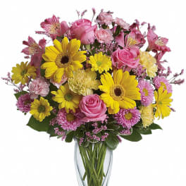 Pink and yellow mixed bouquet in a clear glass vase