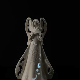 White ceramic angel figurine with cutout details
