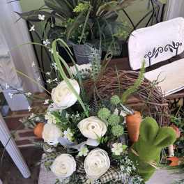 White ranunculus bouquet with small white accents and a plaid ribbon