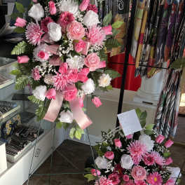Pink and white floral standing sprays on metal easels