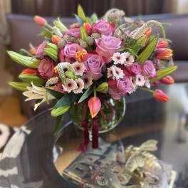 Pink rose and tulip bouquet in a glass vase