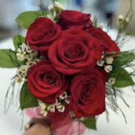 Bouquet of red roses with small white filler flowers