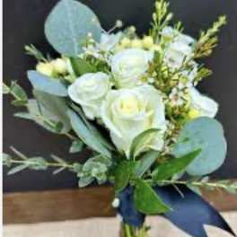 White roses and blue eucalyptus bouquet tied with a navy ribbon