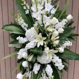 White floral standing spray with lilies and roses