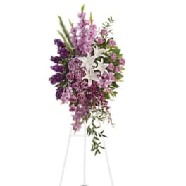 Tall purple and white floral standing spray on an easel