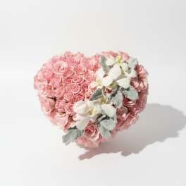 Heart-shaped bouquet of pink roses with white orchids