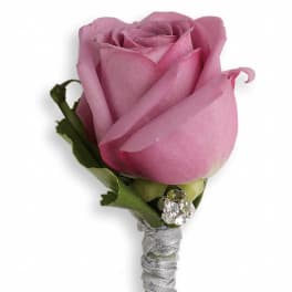 Pink rose boutonniere with silver-wrapped stem and rhinestone accents