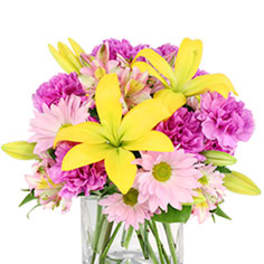 Pink and yellow mixed bouquet in a clear glass vase