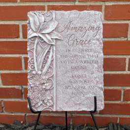 Decorative stone plaque with floral relief and the words "Amazing Grace"