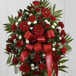 Red floral standing spray with a large ribbon bow