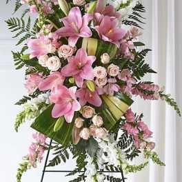 Tall pink and white floral standing spray on an easel