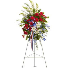 Standing floral spray with red, white, and blue flowers on an easel