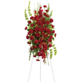 Tall red floral standing spray on a white easel