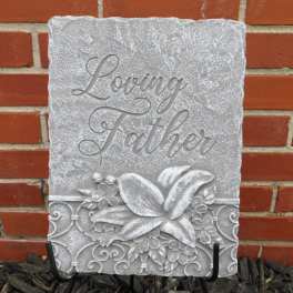 Decorative stone plaque reading "Loving Father" with floral relief