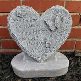 Heart-shaped memorial stone with butterflies and an engraved sympathy message