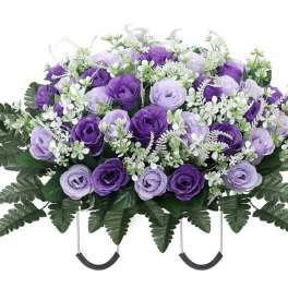 Purple and lavender rose arrangement with white filler flowers in a casket spray