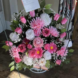 Pink and white mixed flower arrangement in a standing easel display