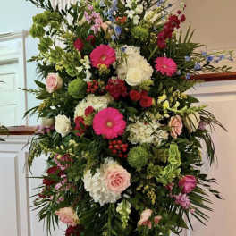 Tall floral spray with pink, white, red, and green blooms