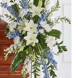 Tall white and blue floral standing spray on an easel