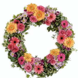 Heart-shaped floral wreath with pink and yellow blooms