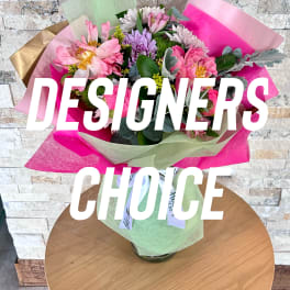 Bouquet of pink and purple flowers wrapped in bright paper