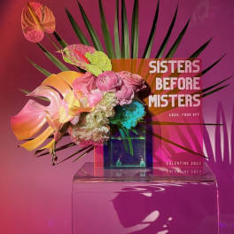 Tropical floral arrangement with pink anthuriums and mixed blooms in a clear vase