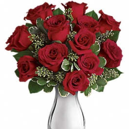 Red roses arranged in a silver vase