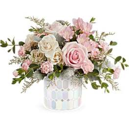 Pink and white rose arrangement in a patterned vase