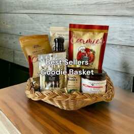Wicker basket filled with packaged snacks and condiments on a wooden table