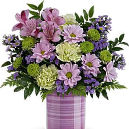 Lavender and green mixed bouquet in a purple vase