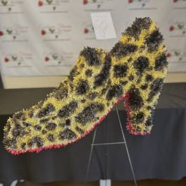 Large floral number-shaped standing arrangement in yellow, black, and pink
