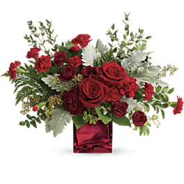 Red roses and carnations in a red glass vase