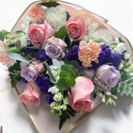Bouquet of pink and lavender roses with white and purple filler flowers