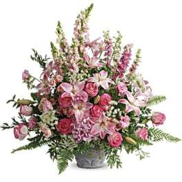 Pink mixed flower arrangement in a gray vase