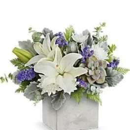 White lilies and purple flowers arranged in a square box