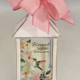 Decorative lantern with a pink bow and floral hummingbird print
