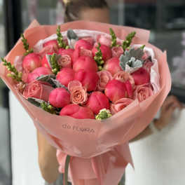 Pink tulip and rose bouquet wrapped in blush paper