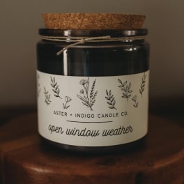 Black candle jar with cork lid and floral label
