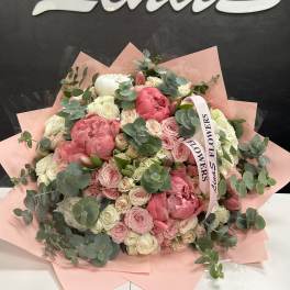 Large pink and white bouquet with eucalyptus and a ribbon