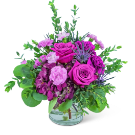 Pink and purple rose bouquet in a clear glass vase