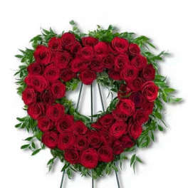Heart-shaped wreath of red roses on a standing easel