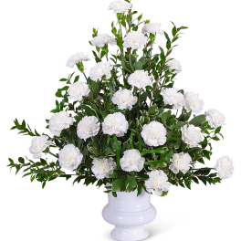 White carnations arranged in a white pedestal vase