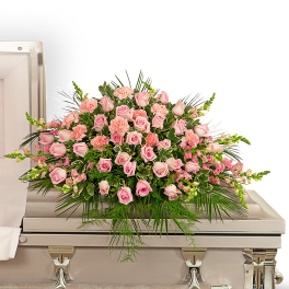 Pink rose and carnation spray on a casket