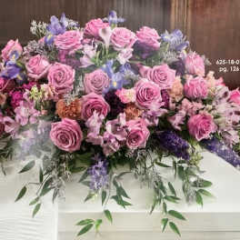 Large pink and lavender floral casket spray with roses and mixed blooms