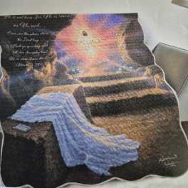 Printed quilt with a glowing religious scene and Bible verse