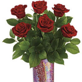 Red roses arranged in a mosaic glass vase