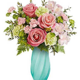 Pink roses and pale flowers in a turquoise vase